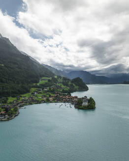 Aerial view of Iseltwald, a small town along the Brienzersee Lake coastline in summertime with rain and low clouds, Bern, Switzerland. - AAEF23388