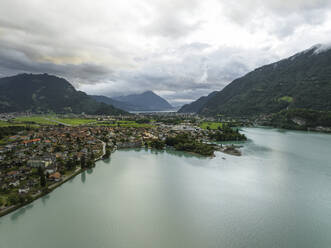 Aerial view of Bonigen, a small town along the Brienzersee Lake with rain and low clouds, Canton of Bern, Switzerland. - AAEF23400