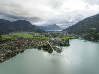 Aerial view of Bonigen, a small town along the Brienzersee Lake with rain and low clouds, Canton of Bern, Switzerland. - AAEF23401