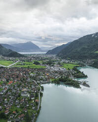 Aerial view of Bonigen, a small town along the Brienzersee Lake with rain and low clouds, Canton of Bern, Switzerland. - AAEF23407