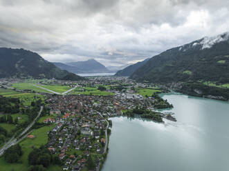 Aerial view of Bonigen, a small town along the Brienzersee Lake with rain and low clouds, Canton of Bern, Switzerland. - AAEF23408