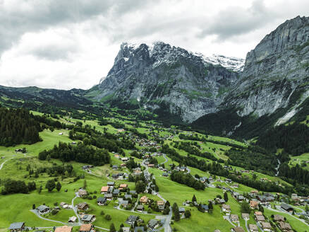 Aerial view of Grindelwald, a small town in the valley with the Wetterhorn mountain in background on the Swiss Alps, Canton of Bern, Switzerland. - AAEF23415