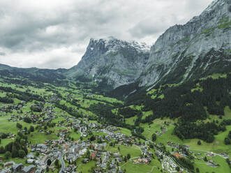 Aerial view of Grindelwald, a small town in the valley with the Wetterhorn mountain in background on the Swiss Alps, Canton of Bern, Switzerland. - AAEF23421