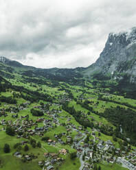 Aerial view of Grindelwald, a small town in the valley with the Wetterhorn mountain in background on the Swiss Alps, Canton of Bern, Switzerland. - AAEF23422