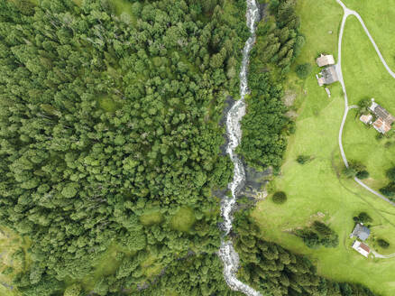 Aerial view of Schwarze Lutschine river in Grindelwald town, Bern, Switzerland. - AAEF23425