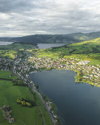 Aerial view of Kussnacht am Rigi, a small town along the Lake Lucerne at sunset with the Lake Zug (Zugersee) in background, Schwyz, Switzerland. - AAEF23454