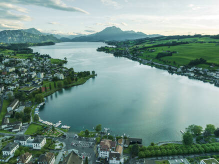 Aerial view of Kussnacht am Rigi town along Lake Lucerne with Mount Pilatus mountain peak in background, Alpnach, Switzerland. - AAEF23462