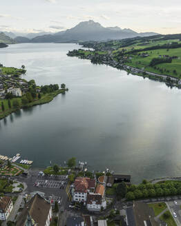 Aerial view of Kussnacht am Rigi town along Lake Lucerne with Mount Pilatus mountain peak in background, Alpnach, Switzerland. - AAEF23464