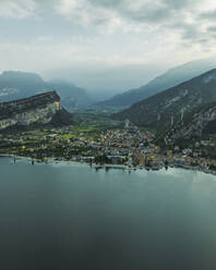 Aerial view of Torbole, a small town along the Garda Lake with Sarca river crossing the village at sunset, Trentino, Italy. - AAEF23514