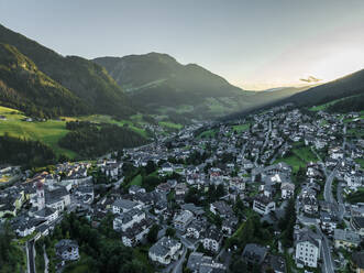 Aerial view of Ortisei, a small village on the Dolomites mountains at sunset, Trentino, South Tyrol in Northern Italy. - AAEF23533