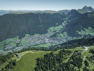 Aerial view of Ortisei town as seen from Alpe di Siusi (Seiser Alm) on the Dolomites mountains, Trentino, South Tyrol in Northern Italy. - AAEF23569