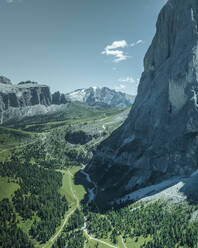 Aerial view of Sassolungo (Langkofel), a mountain peak on the Dolomites mountain range with the Marmolada mountain in background in Trentino, South Tyrol in Northern Italy. - AAEF23587