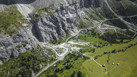 Aerial view of vehicles driving across Passo Gardena road on the Dolomites Mountains, Trentino, South Tyrol, Italy. - AAEF23600