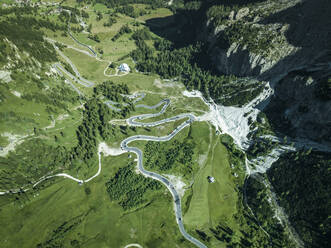 Aerial view of vehicles driving across Passo Gardena road on the Dolomites Mountains, Trentino, South Tyrol, Italy. - AAEF23611