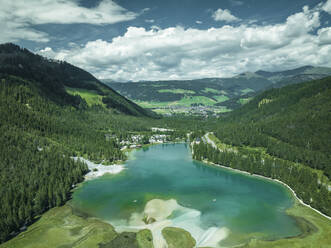 Aerial view of Dobbiaco Lake on the Dolomites mountain range, Toblach, Trentino, South Tyrol, Italy. - AAEF23623