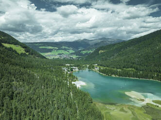 Aerial view of Dobbiaco Lake on the Dolomites mountain range, Toblach, Trentino, South Tyrol, Italy. - AAEF23640