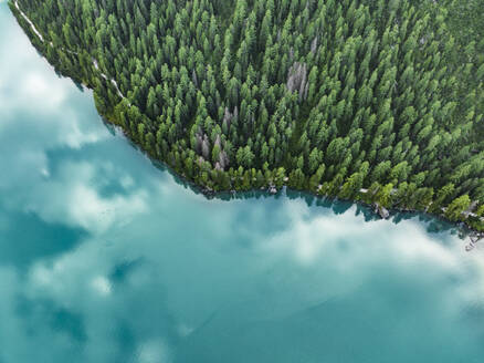 Aerial view of a walking trail along Braies Lake coastline (Pragser Wildsee), a blue mountain lake on Fanes-Senes-Braies Nature Park, Dolomites, Trentino, South Tyrol, Italy. - AAEF23642