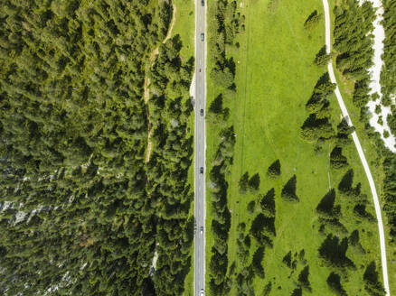 Aerial view of a road crossing the valley across Tre Cime Natural park (Drei Zinnen) on the Dolomites area, Trentino, South Tyrol, Italy. - AAEF23662