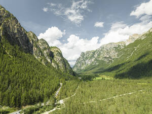 Aerial view of a road across the valley with mountains near Landro Lake (Durrensee) on Dolomites area, Upper Val Pusteria, Trentino, South Tyrol, Italy. - AAEF23663