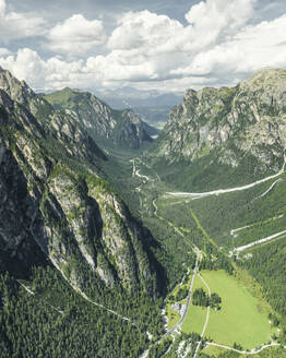 Aerial view of a road crossing the valley across Tre Cime Natural park (Drei Zinnen) on the Dolomites area, Trentino, South Tyrol, Italy. - AAEF23671