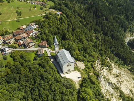 Aerial view of San Martino church in Valle di Cadore, a small town among the mountains on the Dolomites in Veneto, Belluno, Italy. - AAEF23693