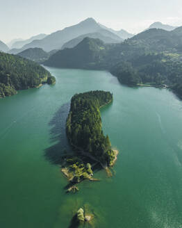 Aerial view of Caprioli Island (Isola dei Caprioli) on Cadore Lake (Lago di Cadore) on the Dolomites Mountains, Belluno, Veneto, Italy. - AAEF23715