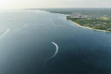 Aerial view of a motorboat sailing along the Adriatic Sea coastline near Pula at sunset, Istria, Croatia. - AAEF23754