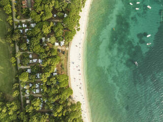 Aerial view of people on the beach in Fazana, a small town along the Adriatic Sea coastline, Istria, Croatia. - AAEF23779