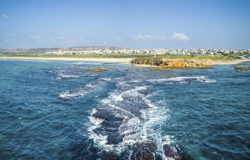 Aerial view of waves over rock formation in the sea, Jisr az-Zarq, Israel. - AAEF23833