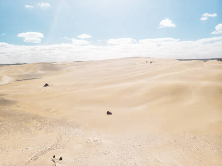 Aerial view of a car driving on sand dunes in Port Lincoln National Park, South Australia. - AAEF24003