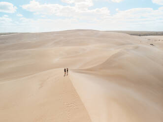 Aerial view of two people standing on a sand dunes in Port Lincoln National Park, South Australia. - AAEF24005