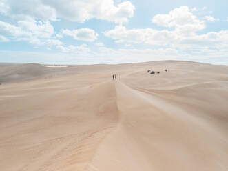 Aerial view of two people standing on a sand dunes in Port Lincoln National Park, South Australia. - AAEF24006