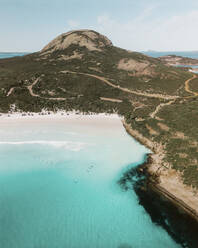 Aerial view of Wharton Beach with turquoise water and surfers in the water, Esperance, Western Australia. - AAEF24015
