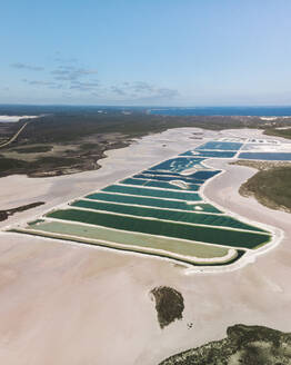 Horizontal panoramic aerial view of a salt mine with different hues of green, Western Australia. - AAEF24023