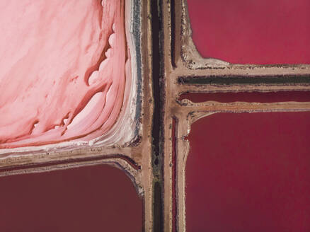 Aerial view of the pink salt lake Hutt Lagoon with a dirt road separating the different colours into four squares of red and pink, Port Gregory, Western Australia. - AAEF24032