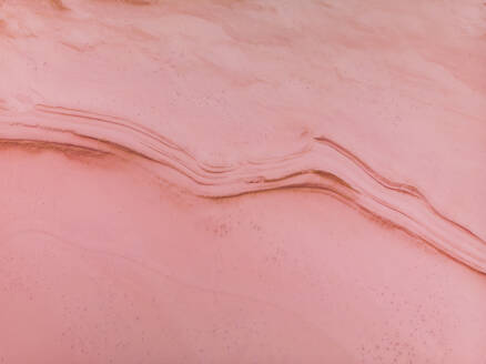 Aerial view of the pink salt lake Hutt Lagoon where the salt is forming an abstract pattern in the pink water, Port Gregory, Western Australia. - AAEF24035