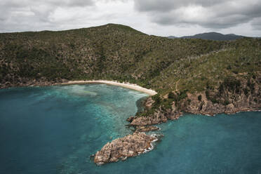 Aerial view of Blue Pearl Bay with turquoise water and green hills, Hayman Island, Australia. - AAEF24042