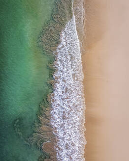 Aerial view of Lunday Bay at low tide, misty morning watching swimmer, Port Quin, Cornwall, United Kingdom. - AAEF24053