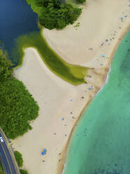 Aerial view of people on the beach along the coast in Pupukea Beach, Waimea Bay, Hawaii island, United States. - AAEF24158