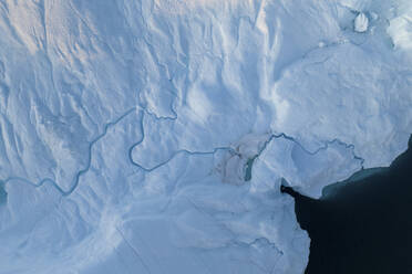 Aerial top-down drone view of an iceberg landscape structure at Ilulissat ice fjord, Greenland, Arctic. - AAEF24168