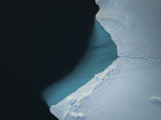 Aerial top-down drone view of an iceberg landscape structure at Ilulissat ice fjord, Greenland, Arctic. - AAEF24177