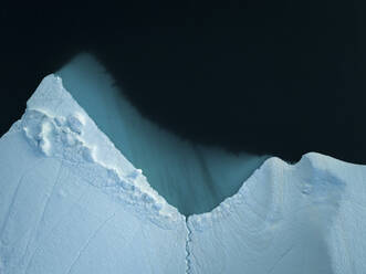 Aerial top-down drone view of an iceberg landscape structure at Ilulissat ice fjord, Greenland, Arctic. - AAEF24178