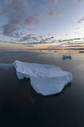 Aerial drone view of a huge iceberg at the Ilulissat ice fjord lagoon in Greenland at morning blue hour, Arctic. - AAEF24200