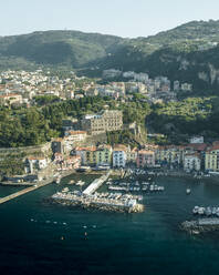 Aerial view of sailing boat along the coast in Sorrento Bay near the harbour, Naples, Campania, Italy. - AAEF24238