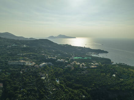 Aerial view of Capri Island at sunset as seen from Sorrento coastline, Campania, Naples, Italy. - AAEF24252