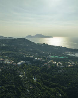 Aerial view of Capri Island at sunset as seen from Sorrento coastline, Campania, Naples, Italy. - AAEF24253