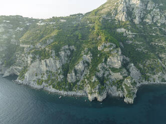 Aerial view of the Amalfi coast at sunset facing the Mediterranean Sea, Positano, Salerno, Campania, Italy. - AAEF24263