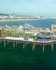 Aerial view of Brighton Palace Pier along the coastline facing the English Channel in Brighton, England, United Kingdom. - AAEF24540