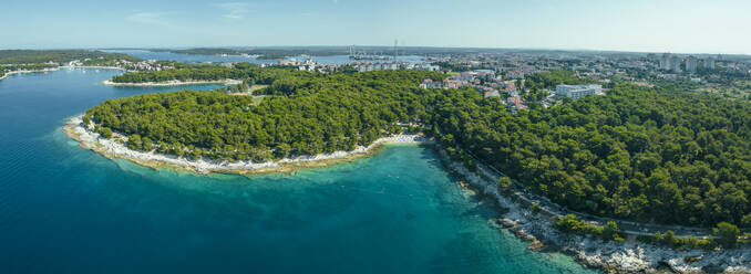 Panoramic aerial view of Gortanova beach, a narrow inlet with turquoise water, Pula, Istria, Croatia. - AAEF24572