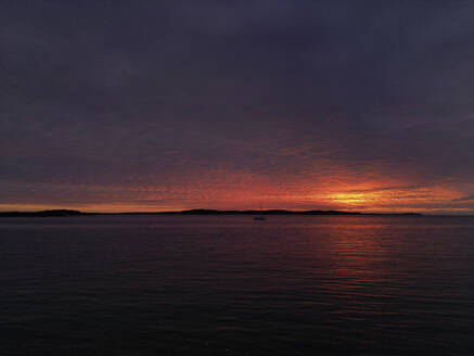 Aerial view of a dramatic sunset along the Adriatic sea coastline near Pula, Istria, Croatia. - AAEF24595